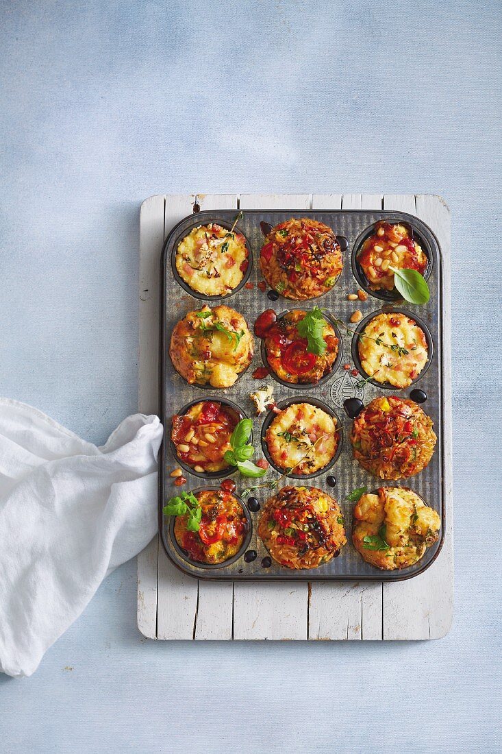 Various savoury muffins in a muffin tin