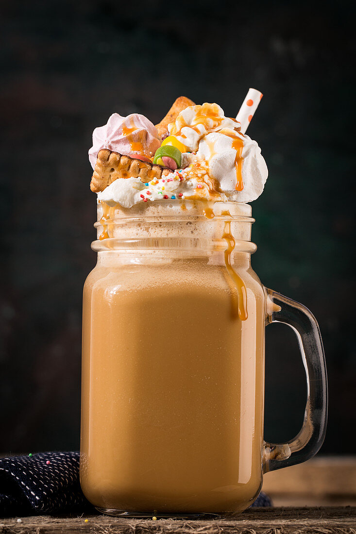 A freak shake with coffee, cream and colourful sweets