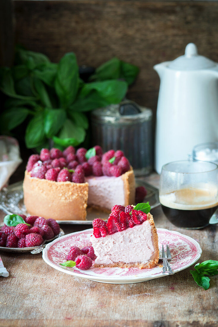 A slice of raspberry cheesecake on a plate
