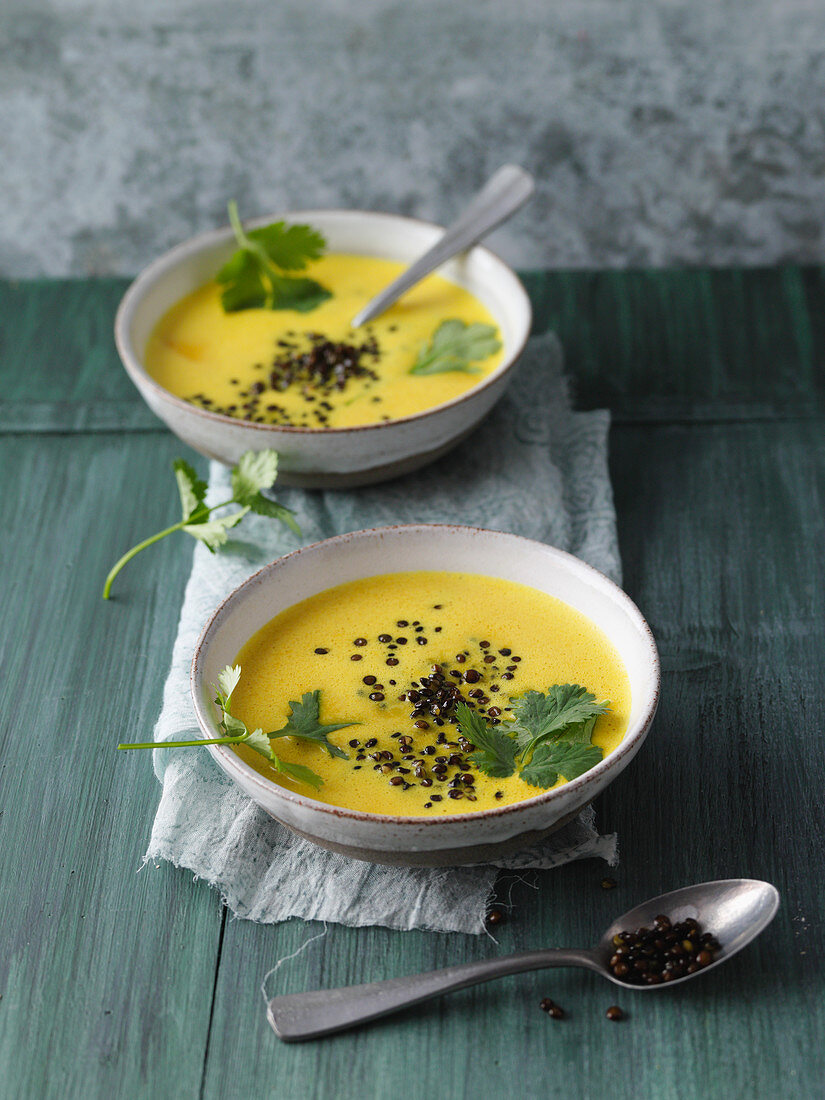 Turmeric and coconut soup with roasted black lentils