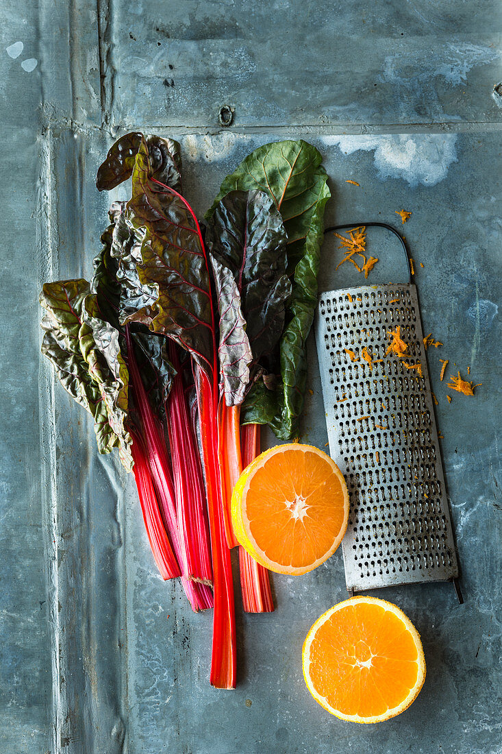 Chard, a halved orange and a grater