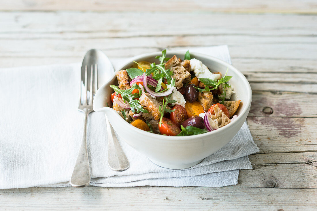 Bread salad with cherry tomatoes, olives and buffalo mozzarella (Italy)