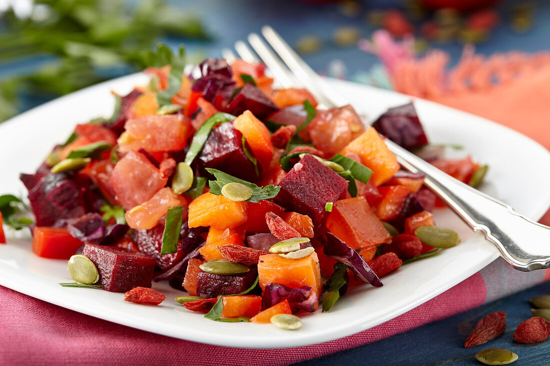 Vegan beetroot salad with carrots and pumpkin seeds