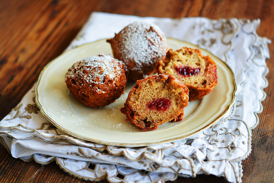 A plate of doughnuts dusted with icing sugar