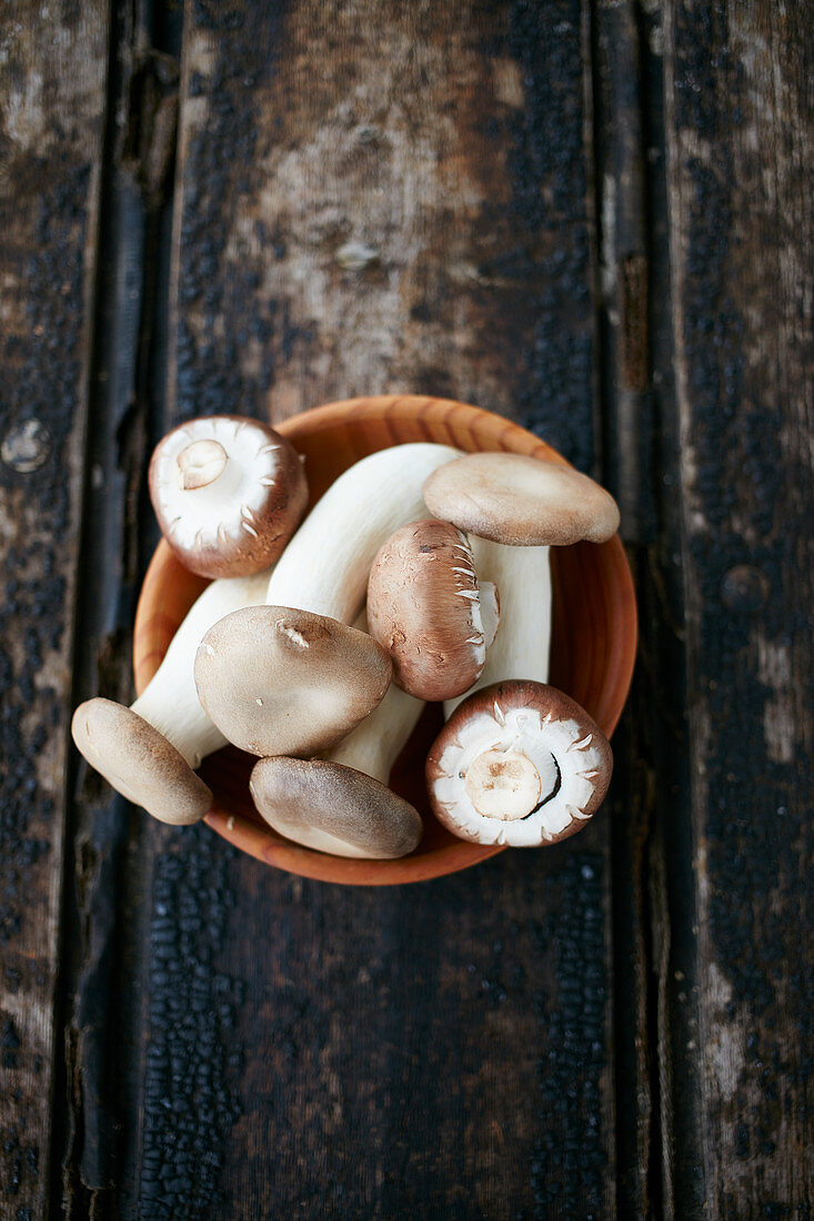 Fresh mushrooms in a wooden bowl