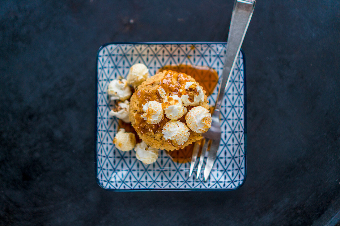 A caramel muffin with popcorn