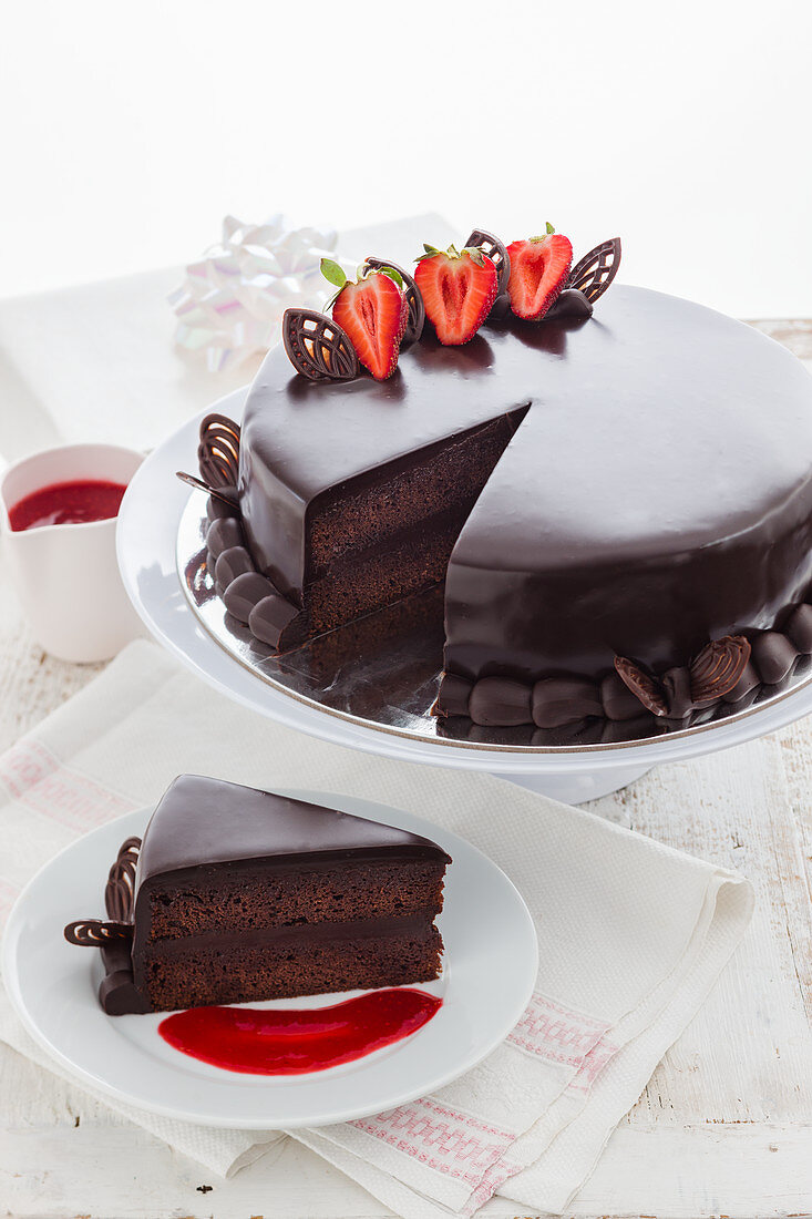 A chocolate cake decorated with strawberries