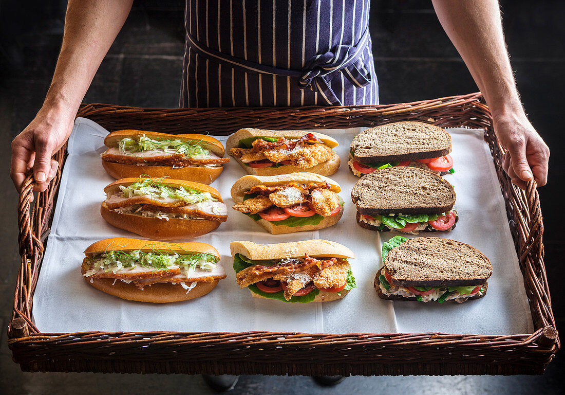 Mixed gourmet sandwiches on a wicker tray