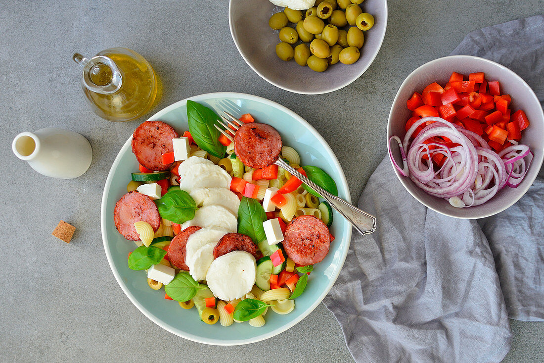 Italian-style pasta salad with olive oil basil mozzarella and olives