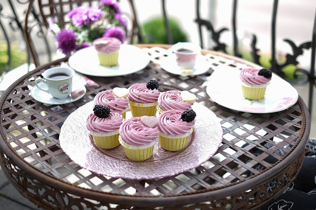 Blackberry cupcakes on a balcony table