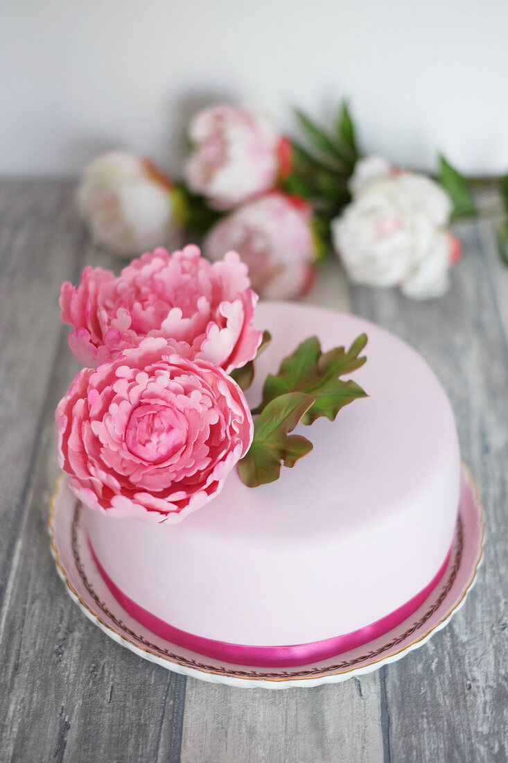 A fondant cake decorated with peonies