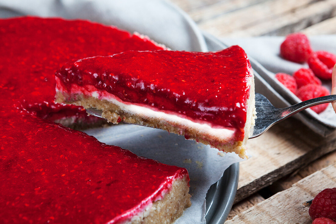 Raw, vegan cashew nut cheesecake with a raspberry topping