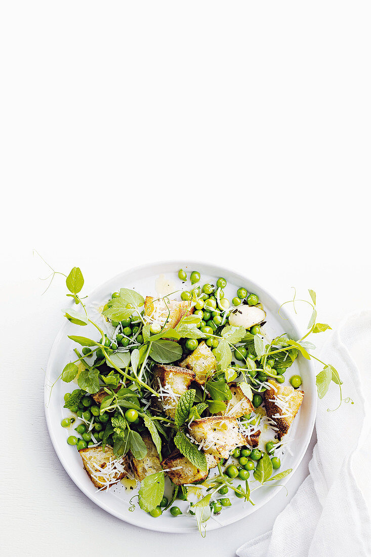 Pea salad with croutons, mint, pea shoots and pecorino