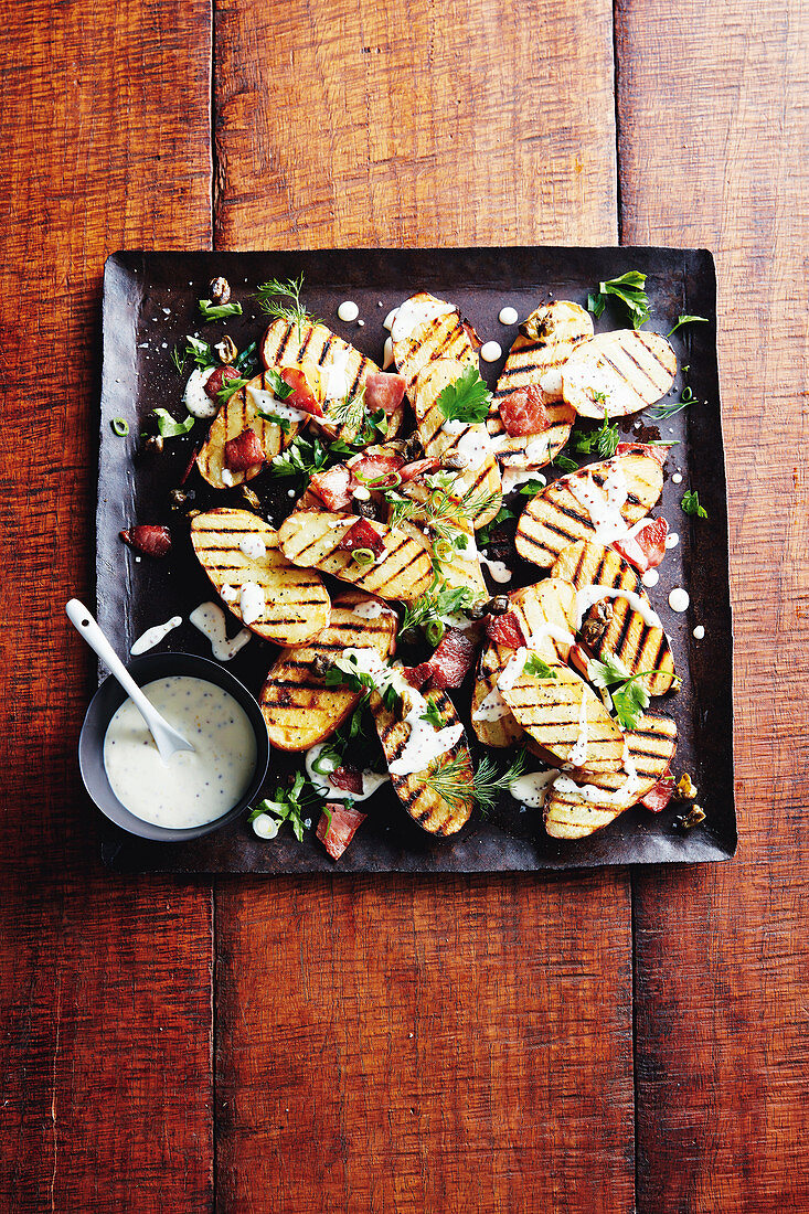 Grilled potatoes with bacon and capers