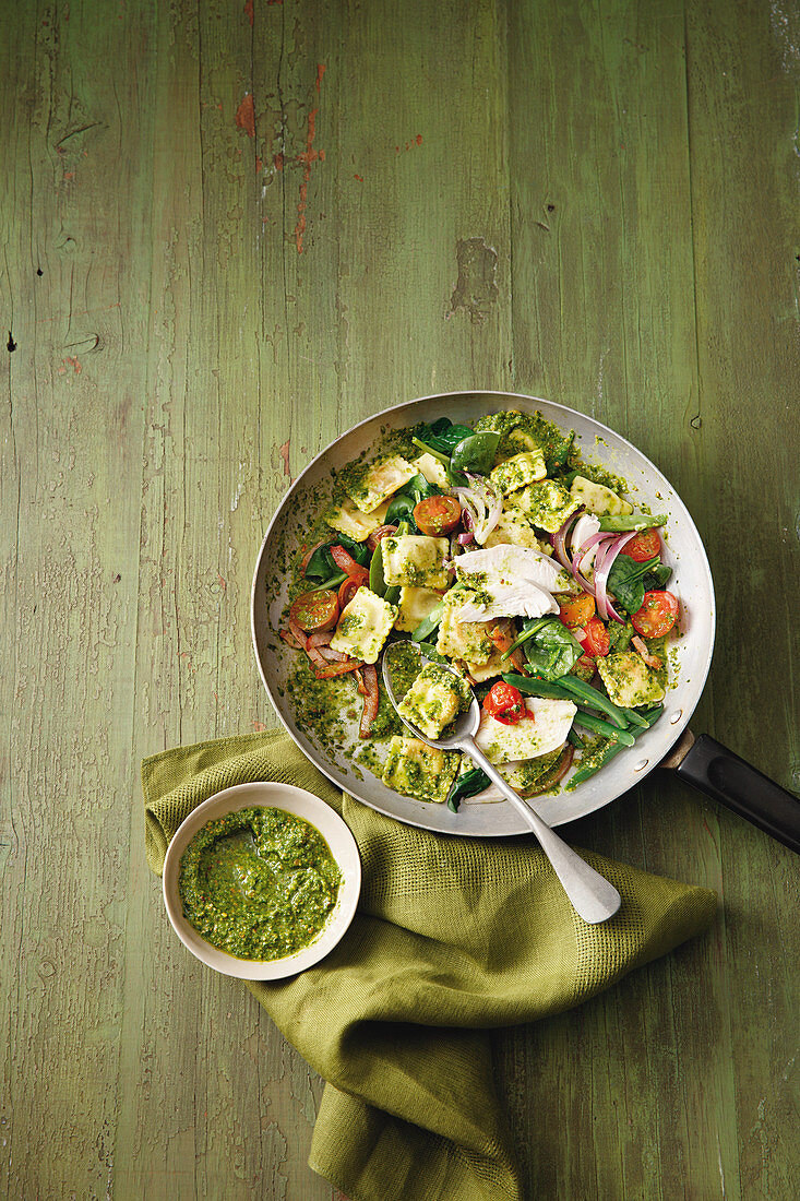 Ravioli with green beans, cherry tomatoes, spinach pesto and basil