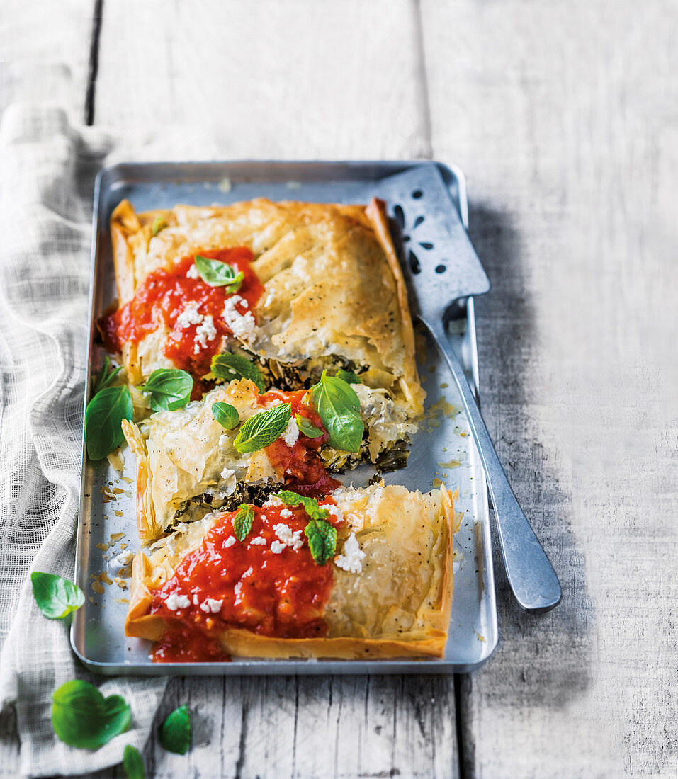 A vegetable pasty with ricotta and tomato sauce