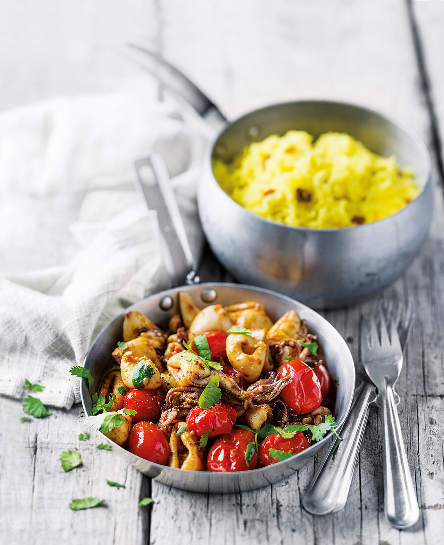 Spicy calamari with cherry tomatoes and yellow rice