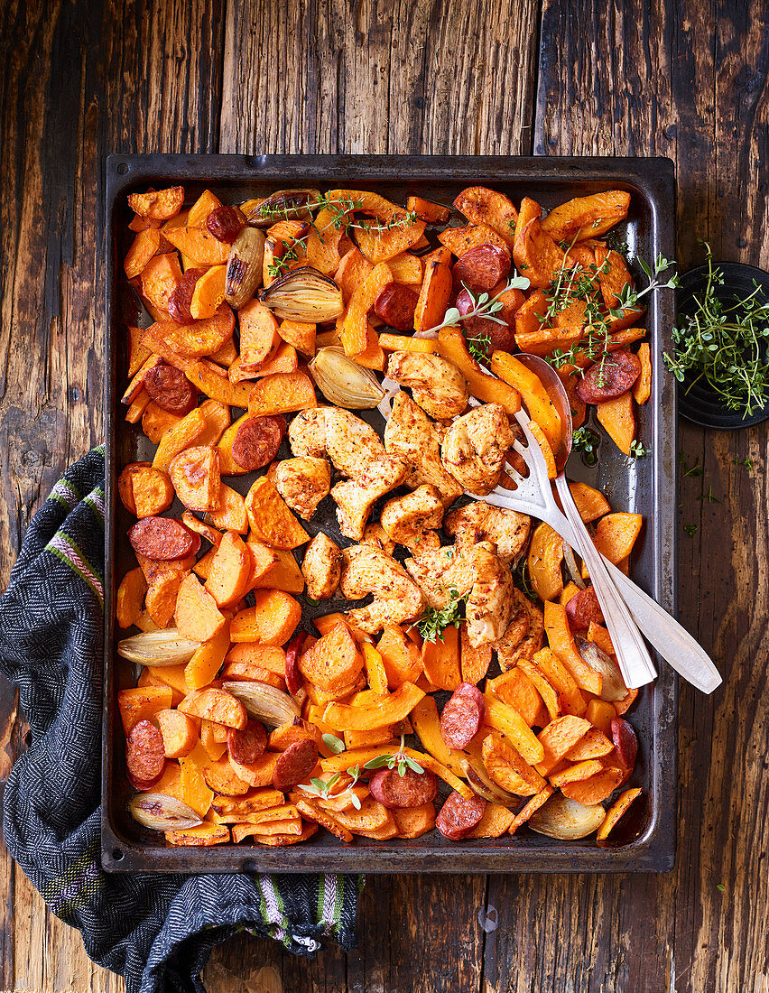 Oven-baked cajun chicken with sweet potatoes and chorizo