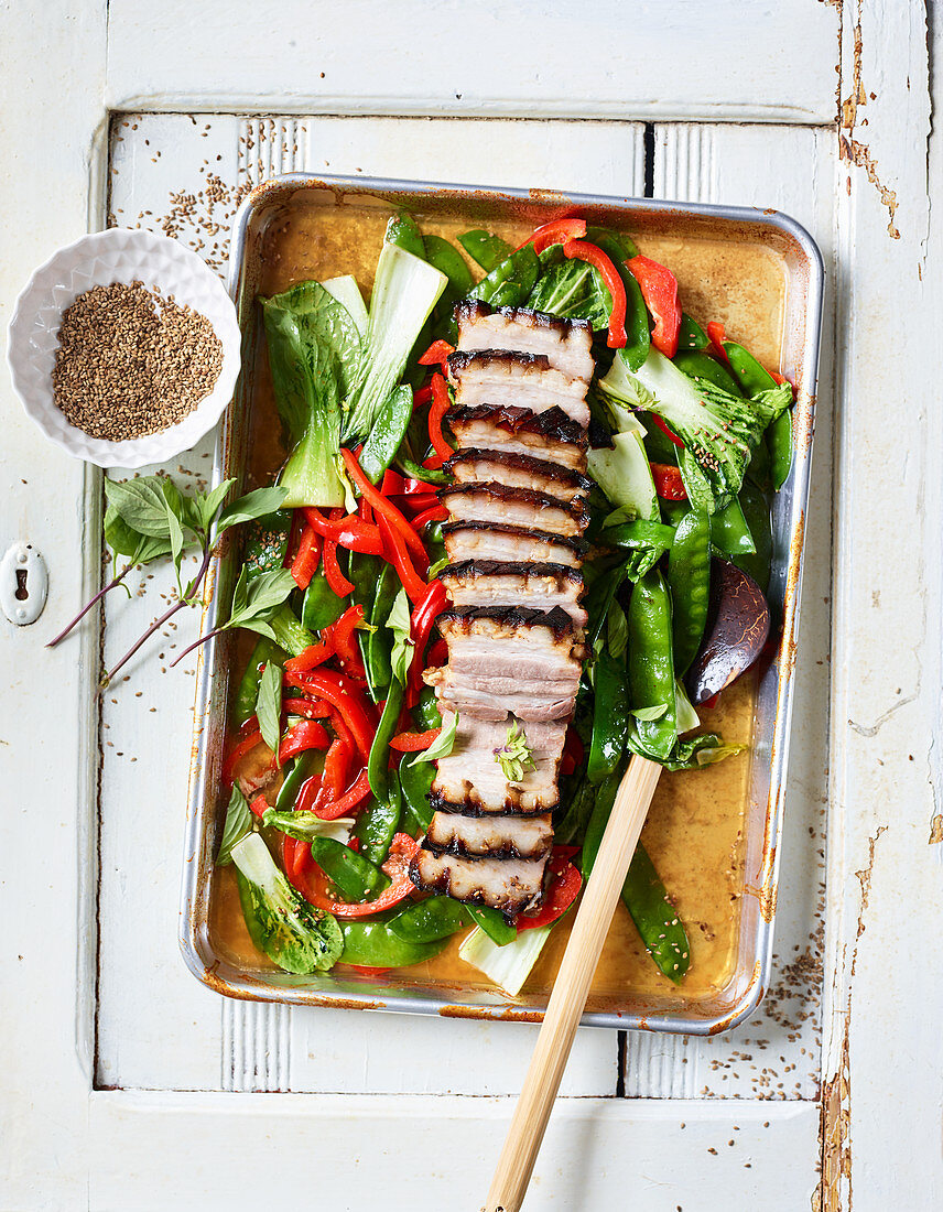 Oriental style honey-roasted ham on a baking tray