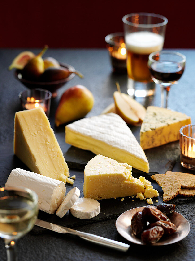 A cheese board with fruit and wine