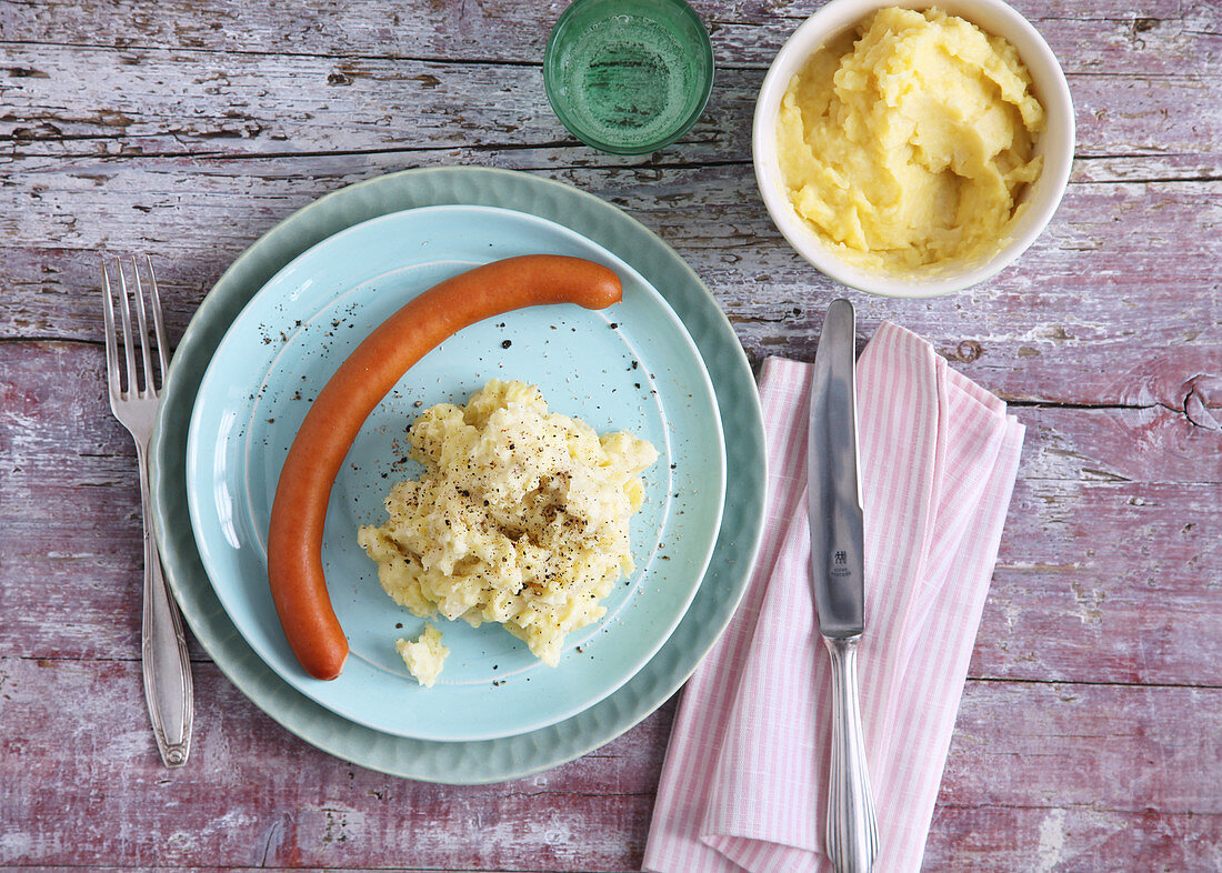 Frankfurter sausage with mashed potatoes for mum and mashed for baby