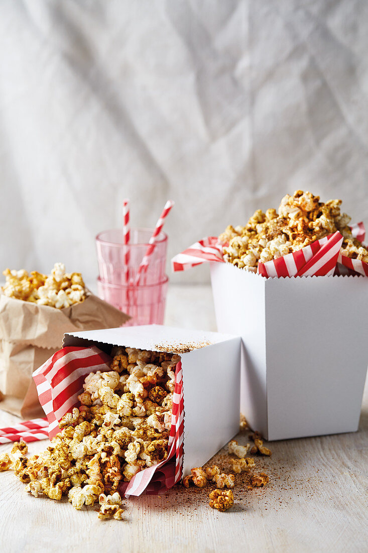 Spiced popcorn in cardboard boxes with napkins
