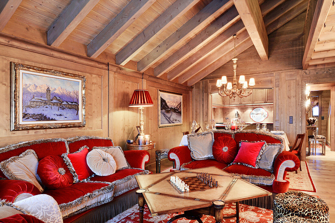 Opulent velvet sofas in red and grey in extravagant living room