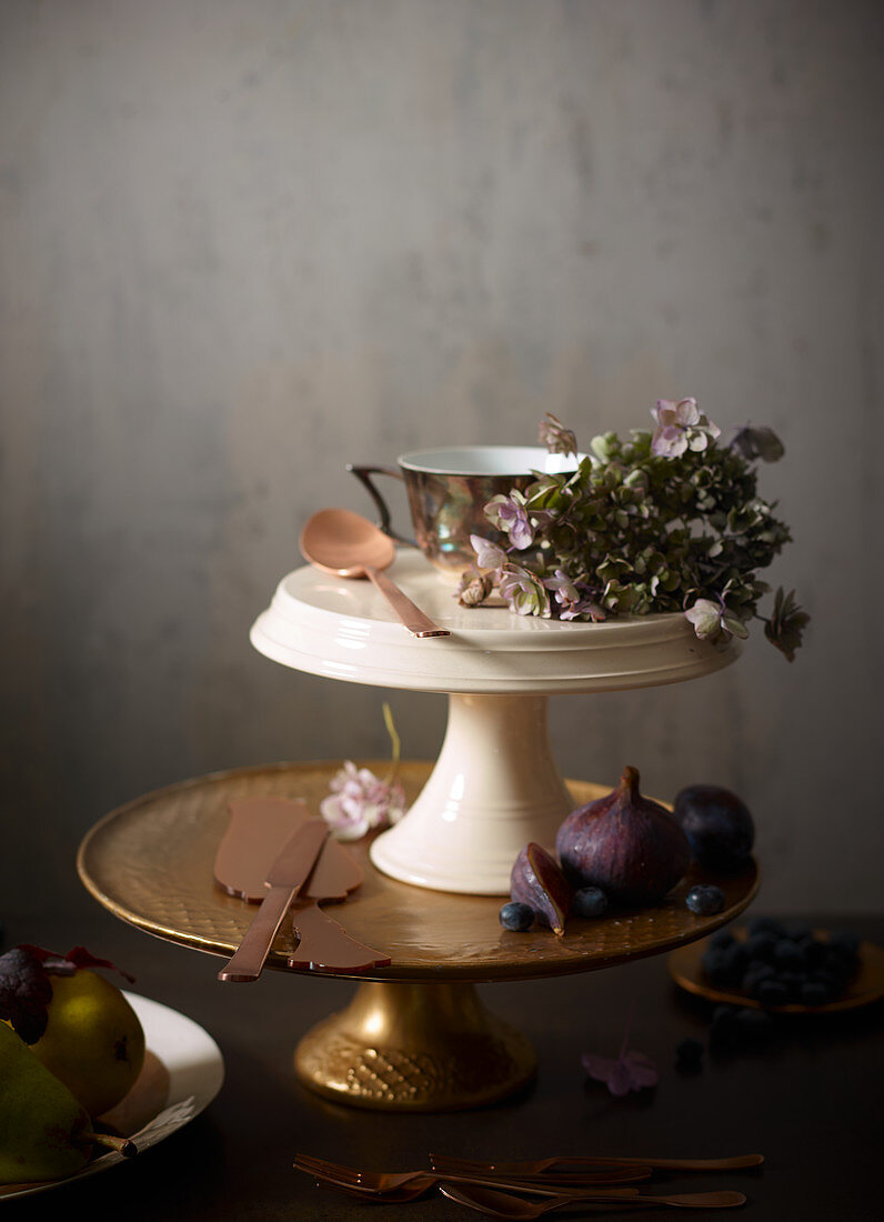 Autumnal fruits and flowers on various cake stands