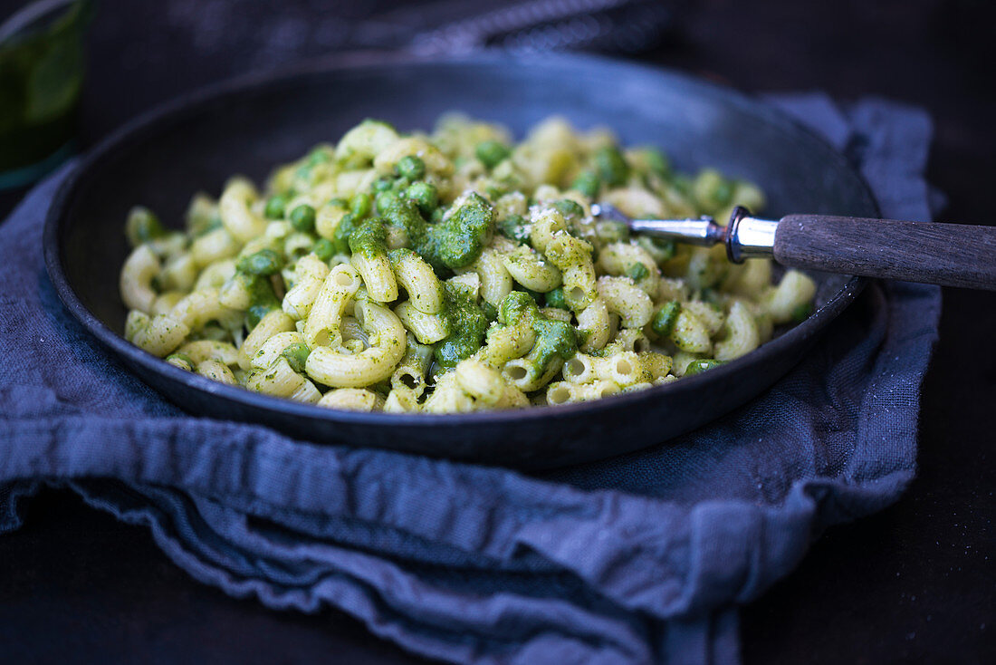 Pasta with celeriac leaf pesto, peas and grated almonds (vegan)