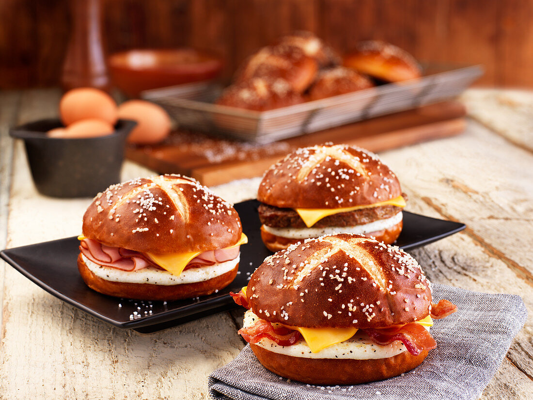 Lye bread rolls with bacon, cheese and fried egg