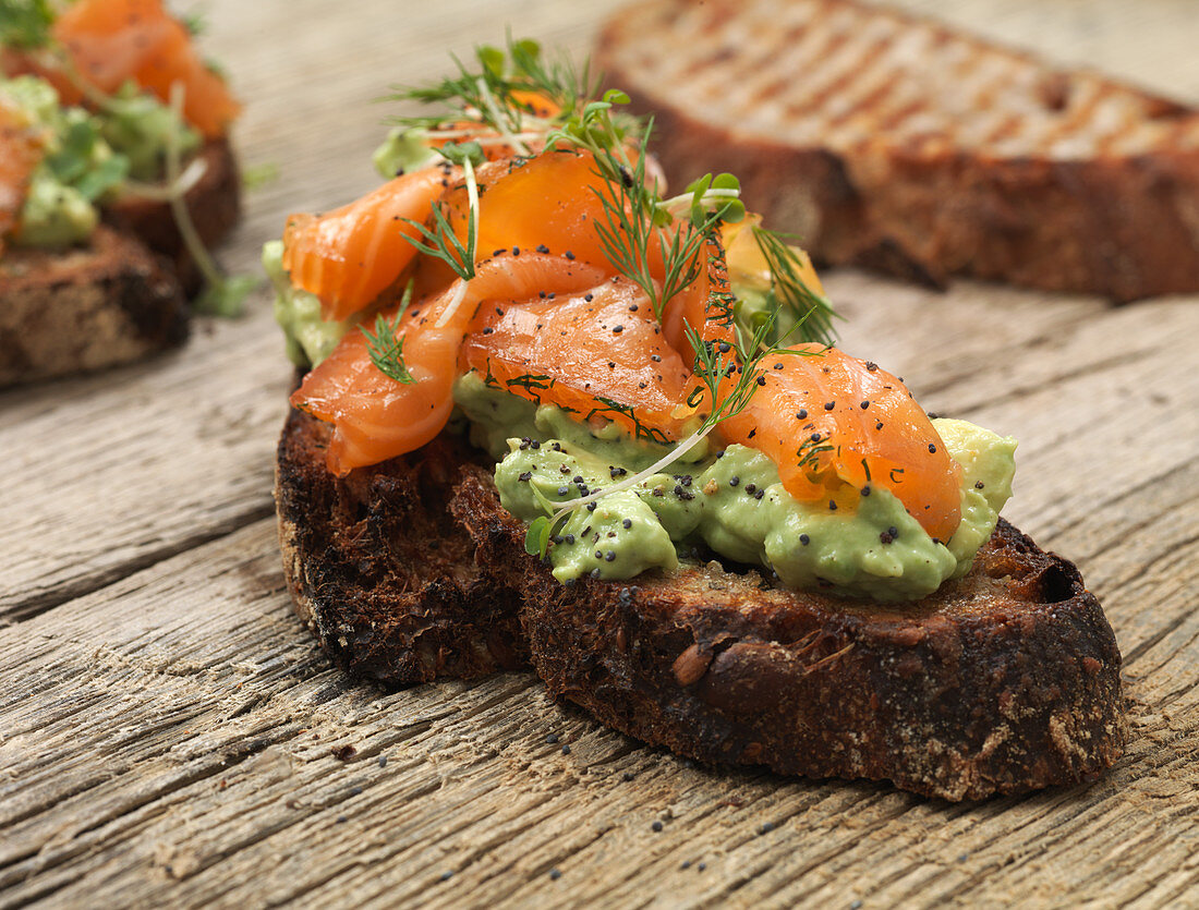 Grilled bread with avocado, smoked salmon and herbs