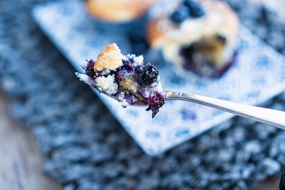 A piece of a blueberry muffins on a fork