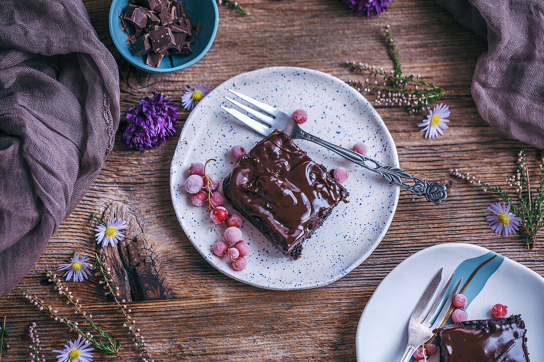 Chocolate sweet potato brownies served on dessert plates on rustic wooden table