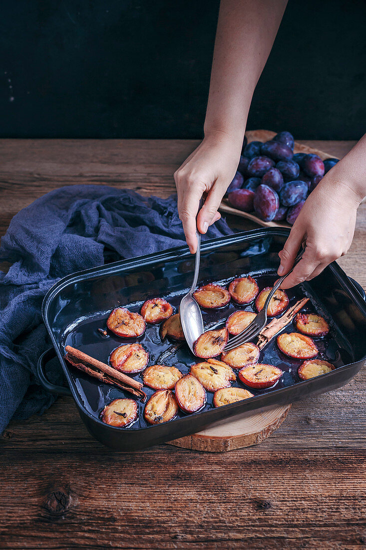 Roasted plums with vanilla and cinnamon in a baking dish