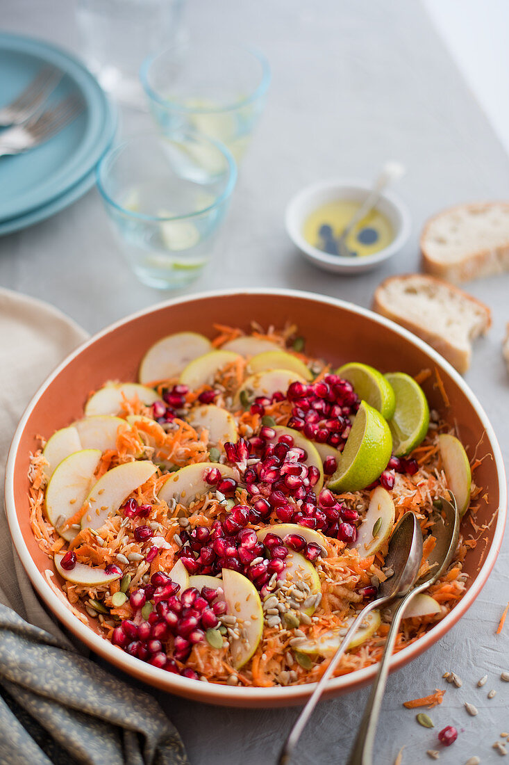 Carrot, celeriac and apple salad with pomegranate seeds, lime juice and seeds