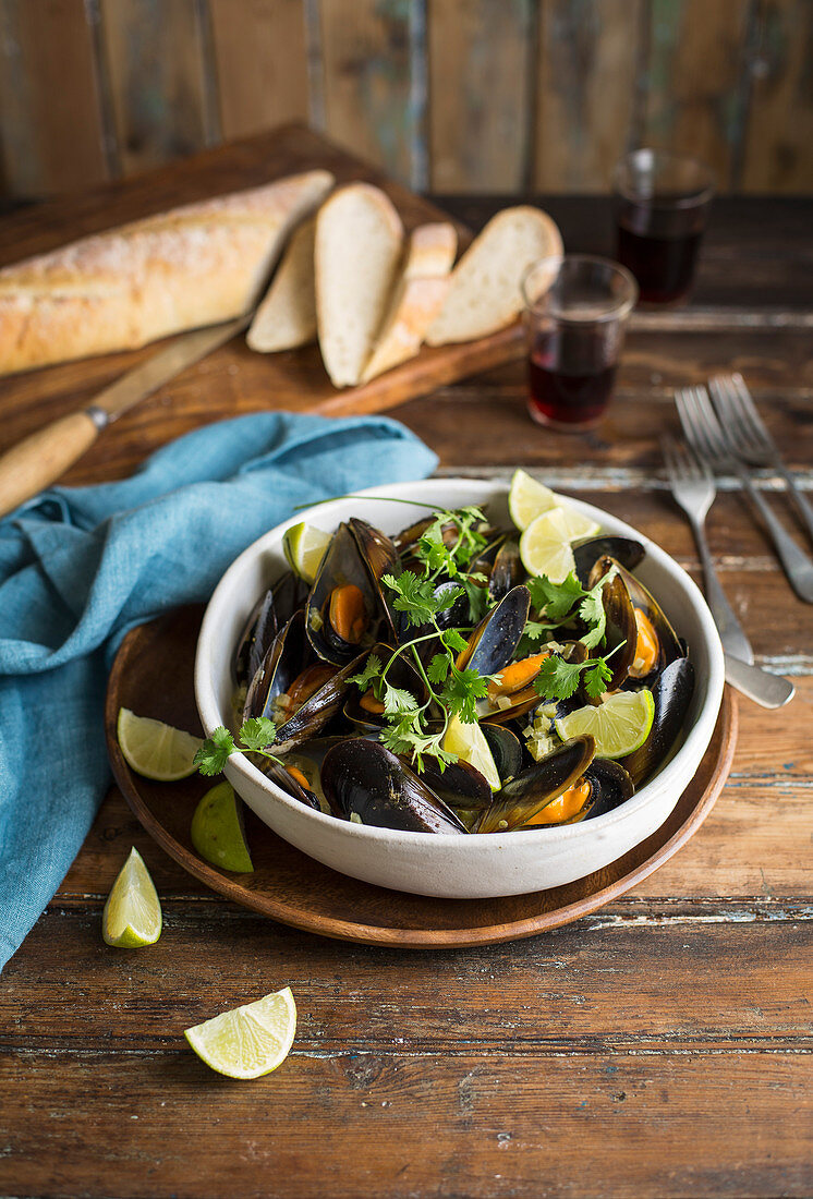 Steamed mussels with coriander leaves and limes