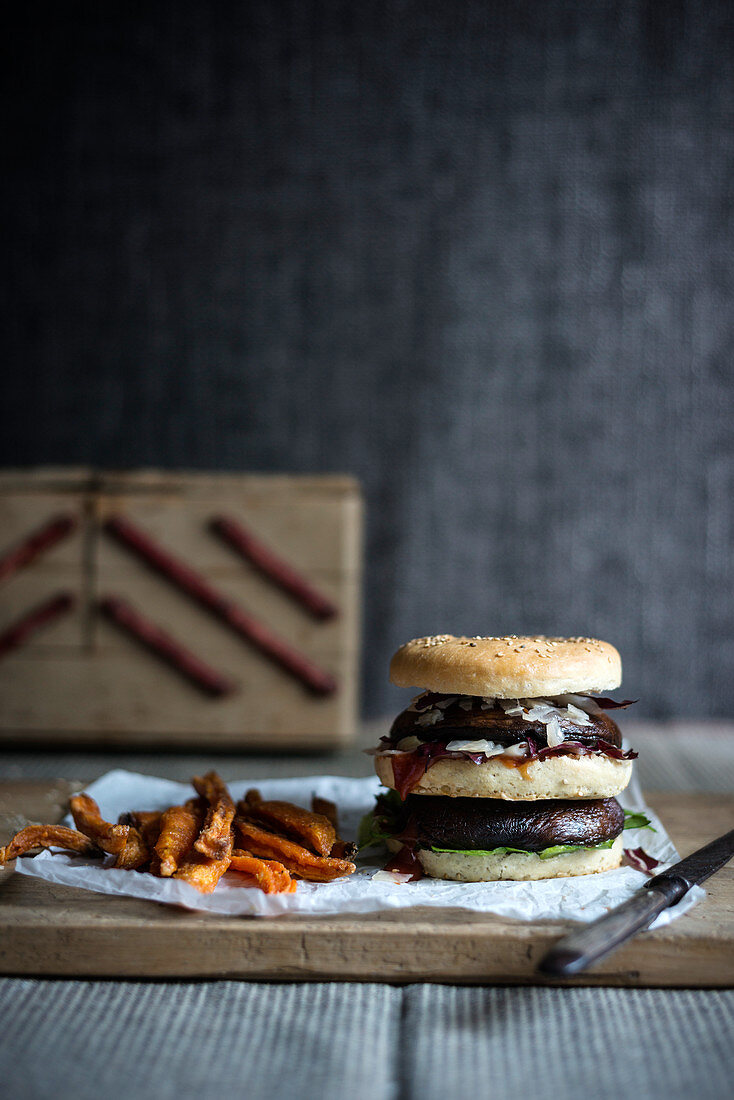 A double portobello burger with sweet potato fries (vegan)