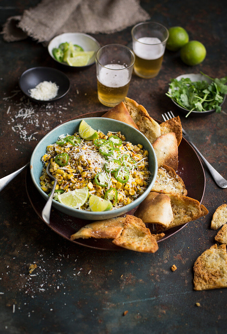 Esquites (corn salad from Mexico) and pita crisps