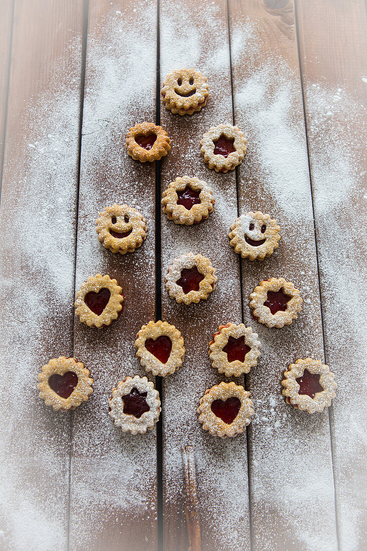Christmas jam biscuits arranged in a tree shape on a wooden surface