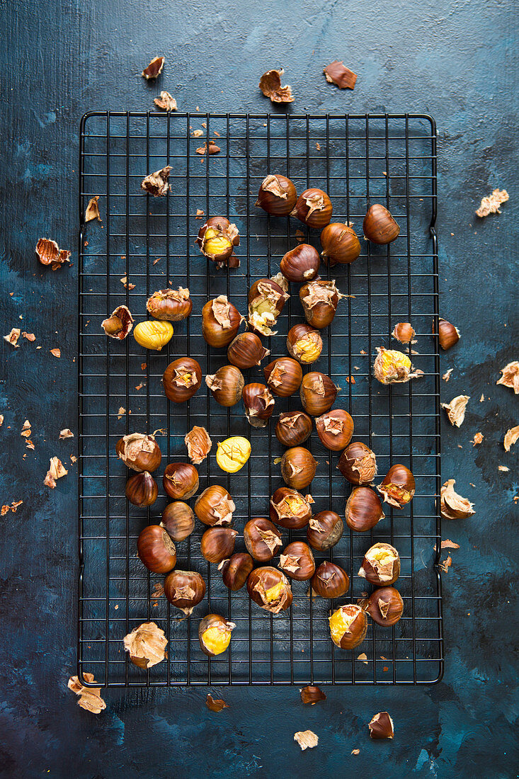 Roasted chestnuts on a cooling rack (seen from above)