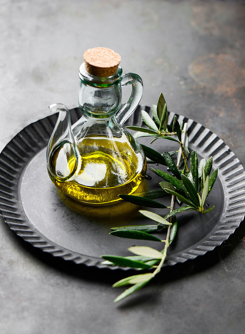 Olive oil with an olive sprig