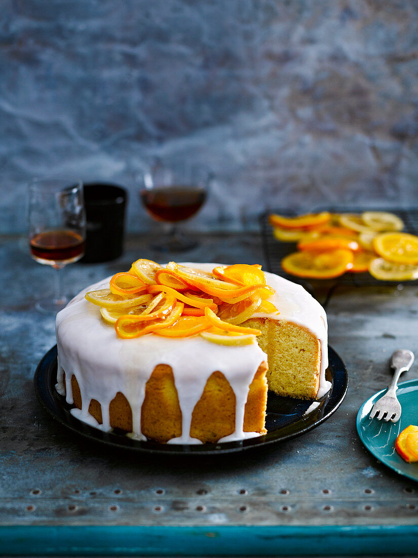 Butter cake with citrus fruits and sugar icing