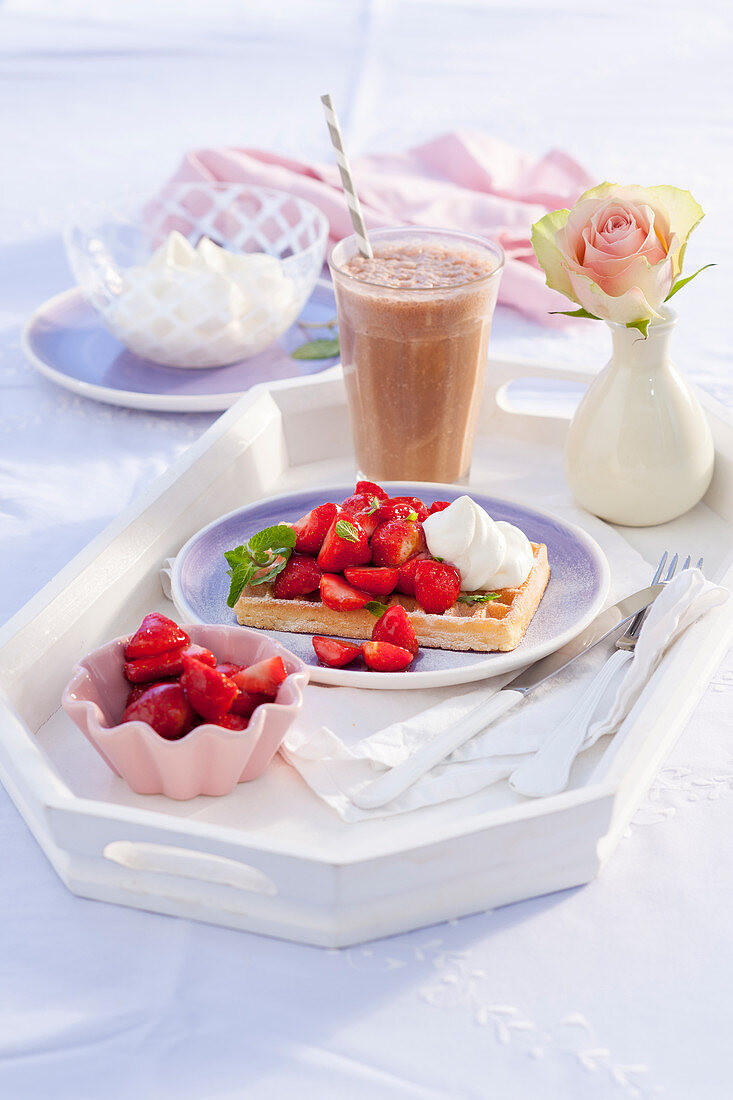 Warm caramel waffles with marinated strawberries and whipped cream