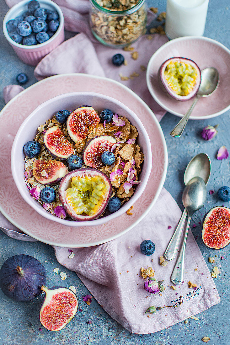 Muesli with figs, milk, passion fruit, blueberries and rose petals