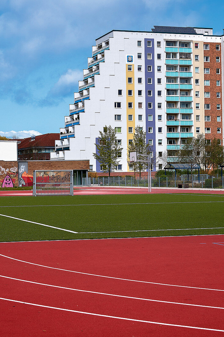 A view of pre-fab apartment buildings from a sports field, Evershagen, Rostock, Germany