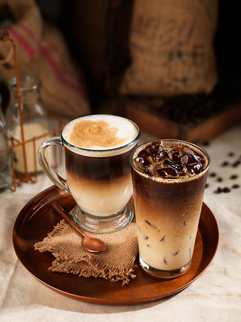 Two coffee drinks on a tray