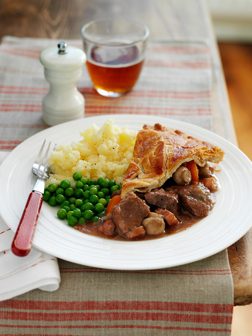 Beef and ale pie with mashed potatoes and peas (England)