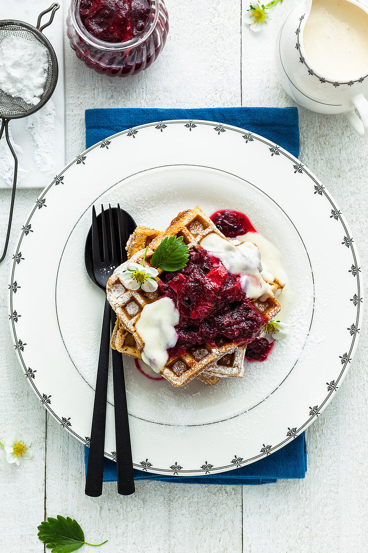 Waffles with rhubarb, berries and icing sugar