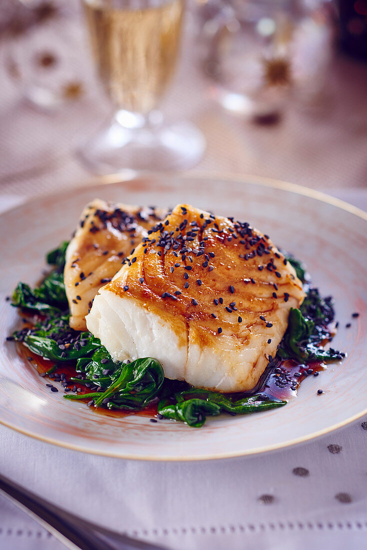 Cod with sesame seeds on a bed of spinach