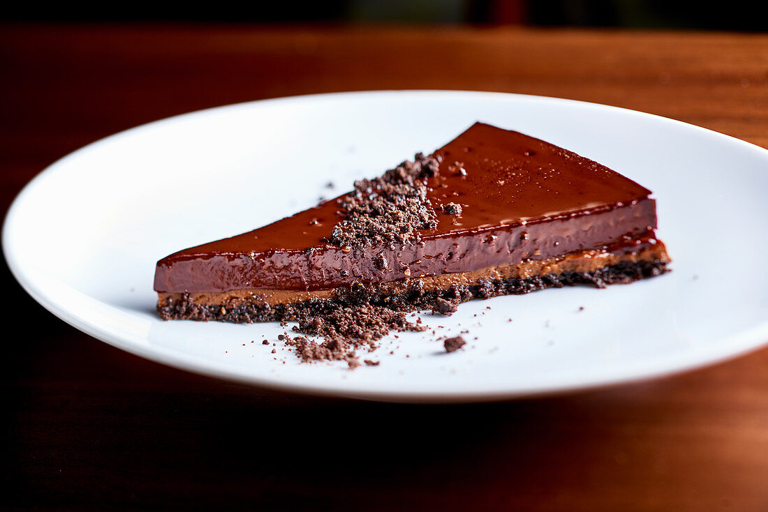 A slice of chocolate tart on a white plate